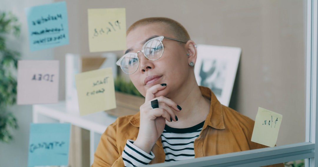 Team brainstorming with sticky notes on a glass wall